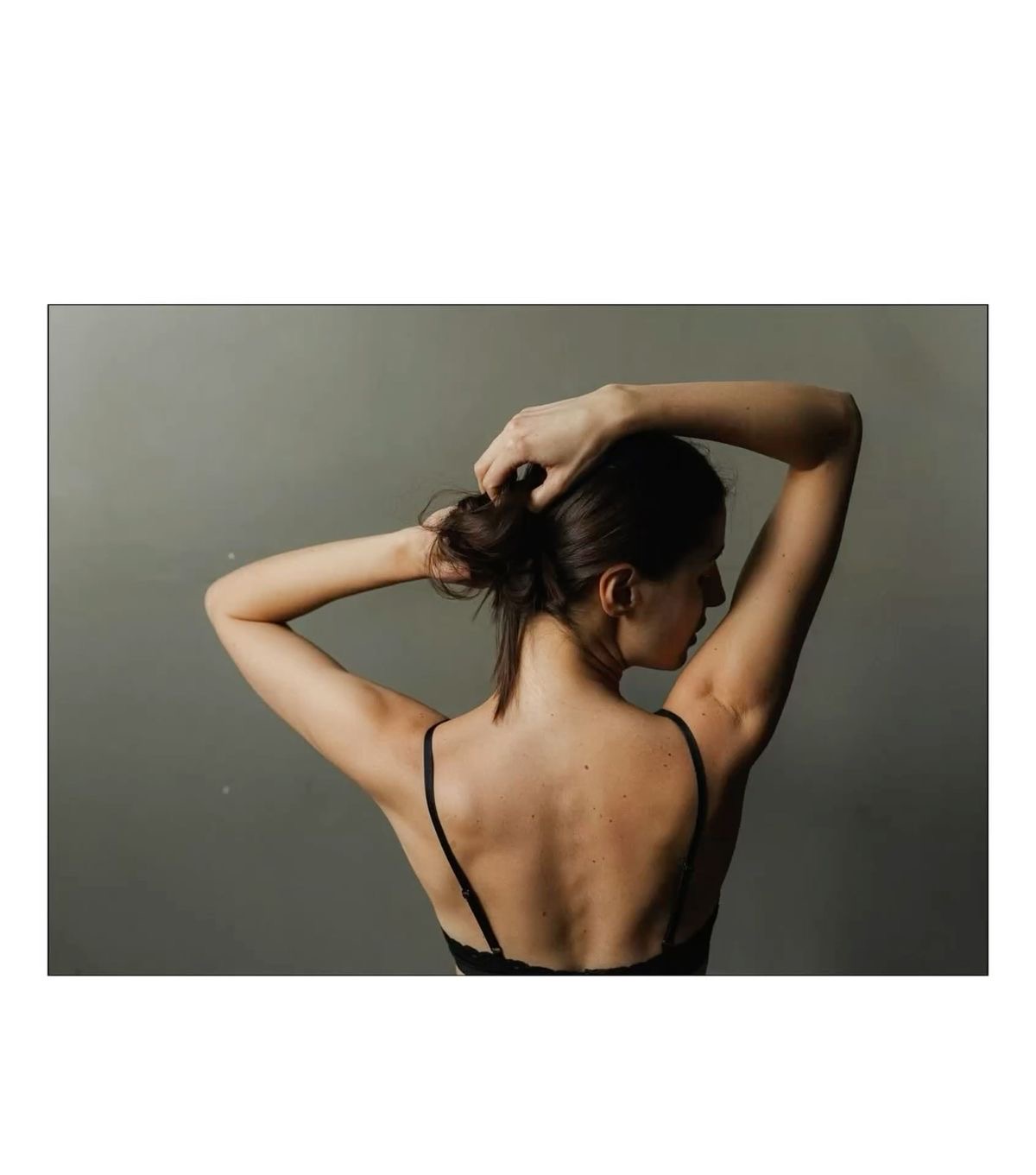 Teresa photographed from behind in a quiet sculptural pose.